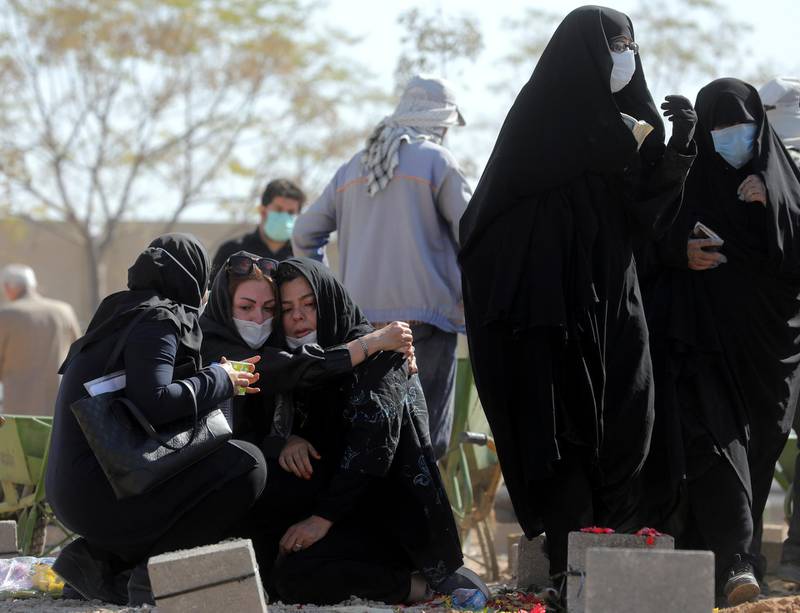 Mourners attend the funeral of a person who died from Covid-19 at the Behesht-e-Zahra cemetery just outside Tehran, Iran. AP