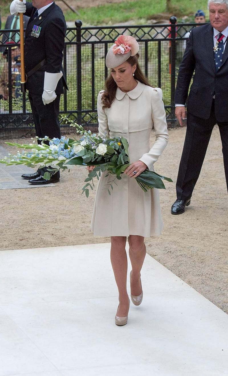 MONS, BELGIUM - AUGUST 04:  Catherine, Duchess of Cambridge lays a floral tribute at St Symphorien Military Cemetery on August 4, 2014 in Mons, Belgium. Monday 4th August marks the 100th Anniversary of Great Britain declaring war on Germany. In 1914 British Prime Minister Herbert Asquith announced at 11pm that Britain was to enter the war after Germany had violated Belgium's neutrality. The First World War or the Great War lasted until 11 November 1918 and is recognised as one of the deadliest historical conflicts with millions of casualties. A series of events commemorating the 100th Anniversary are taking place throughout the day.  (Photo by Arthur Edwards - WPA Pool /Getty Images)