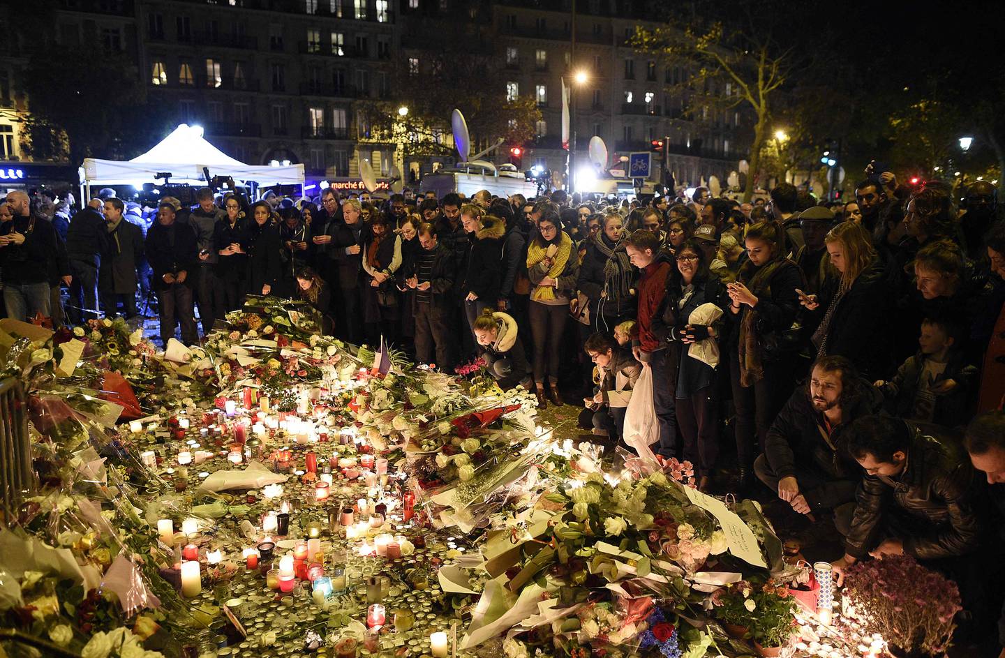 People gather at a memorial in front of the Bataclan theatre in November 2015. AFP