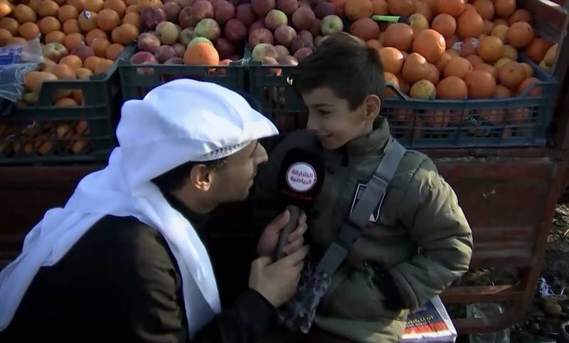 Sharjah Sport TV correspondent Ali Al Kalabani (L) with Mustafa (R) in Basra Market. Credit: Screenshot