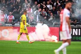 Ajax supporters throw flares onto the pitch during the Dutch Eredivisie match between Ajax and Feyenoord. The match was abandoned after 56 minutes. EPA