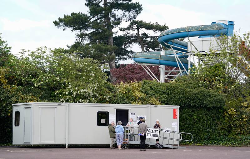 People arrive to vote at a mobile polling station at Aldershot Lido in Hampshire. PA