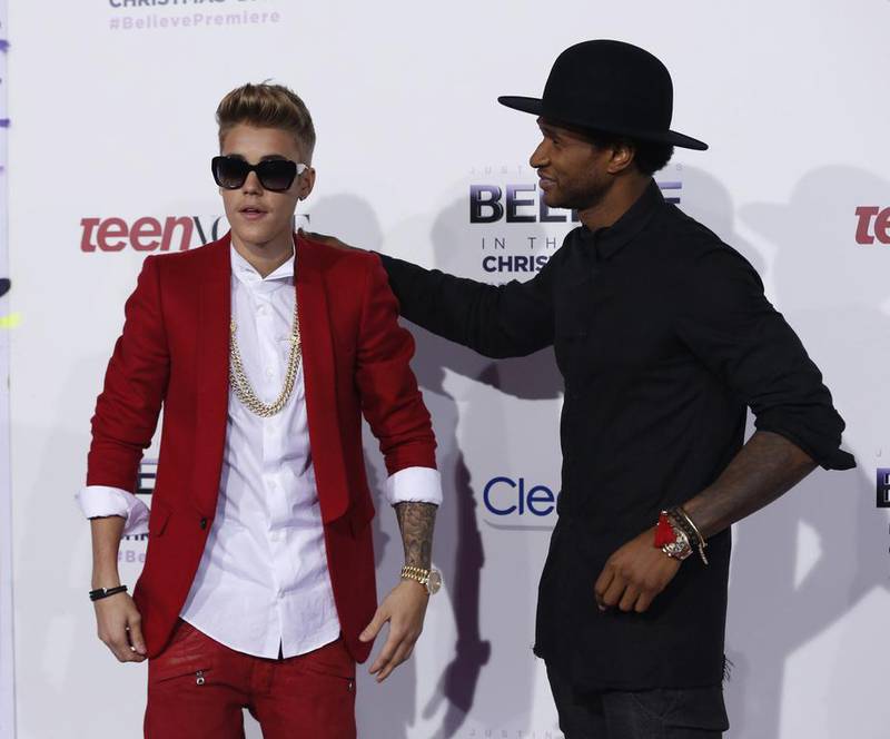 Justin Bieber, in red tailoring, and Usher attend the premiere of 'Justin Bieber's Believe' in Los Angeles, California,  on December 18, 2013. Reuters