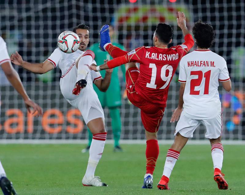 United Arab Emirates' forward Ali Mabkhout al Hajeri, left, and Bahrain's midfielder Kamil Al Aswad challenge for the ball. AP Photo