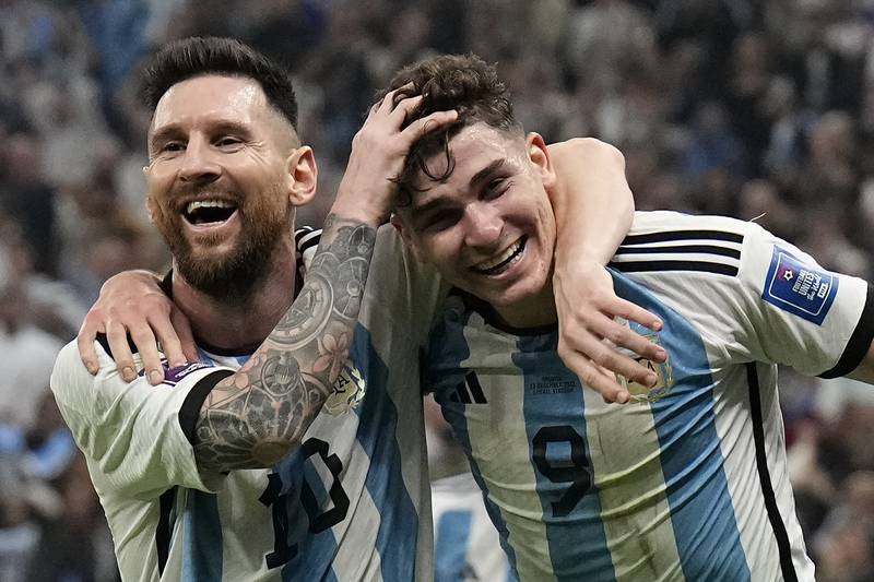 Argentina's Lionel Messi, left, and Argentina's Julian Alvarez celebrate after scoring. AP