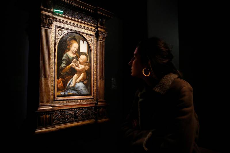 A journalist watches the painting "Benois Madonna" by Leonardo Da Vinci, at the Louvre museum, in Paris.  AP