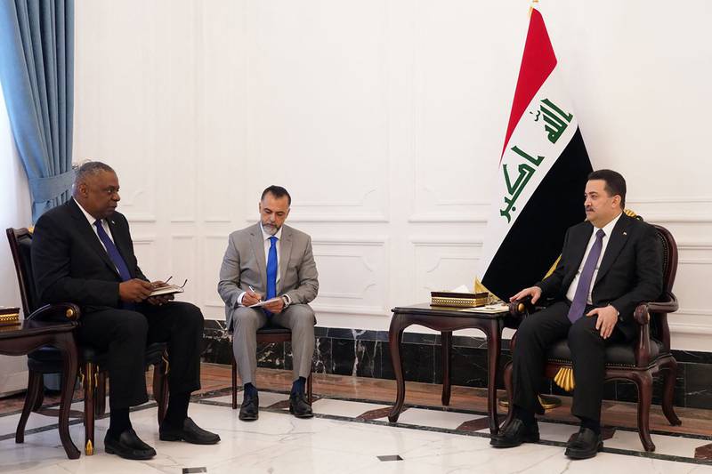Iraq's Prime Minister Mohammed Shia Al Sudani, right, meets US Defence Secretary Lloyd Austin, left, in Baghdad. AFP