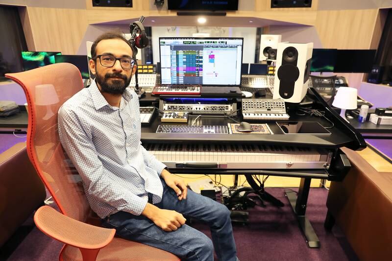 Navneeth Balachanderan, the studio engineer who leads the sound section, in the high-tech control room at the studio. Pawan Singh / The National
