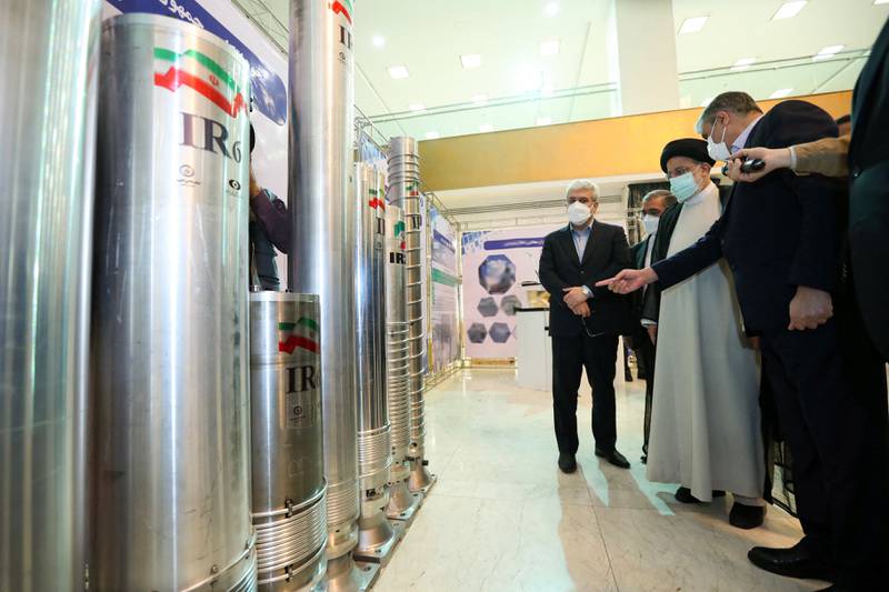 President Ebrahim Raisi, second right, is accompanied by Atomic Energy Organisation of Iran chief Mohammad Eslami, at Nuclear Technology Day in Tehran in April 2022. Iranian presidency / AFP