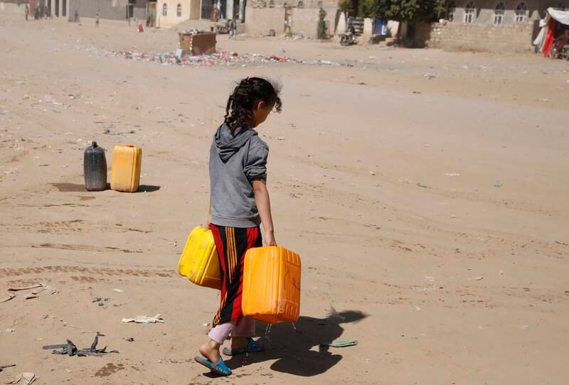A Yemeni girl carries water from a donated tank on the outskirts of Sanaa, on November 24. EPA