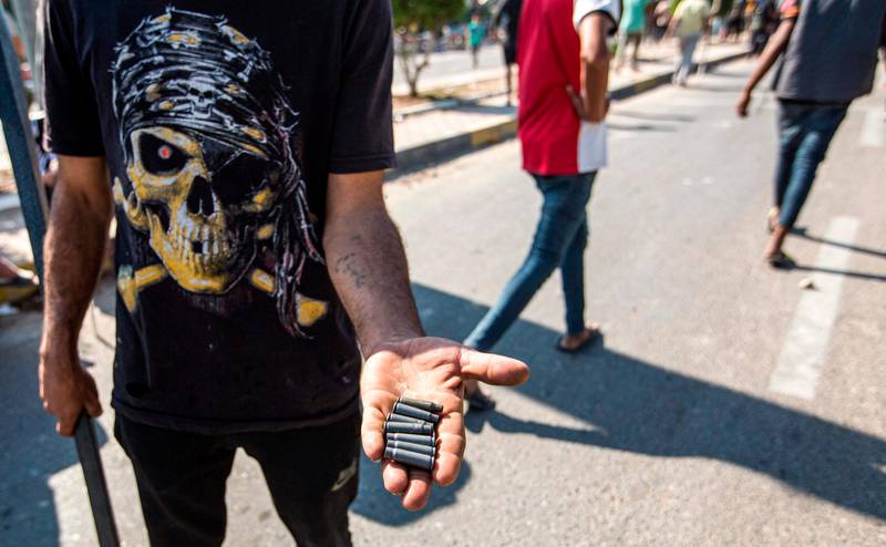 An Iraqi protester holds out spent bullet casings at a demonstration in the southern port of Umm Qasr after security forces attempted to break up crowds blocking the road to the port. AFP