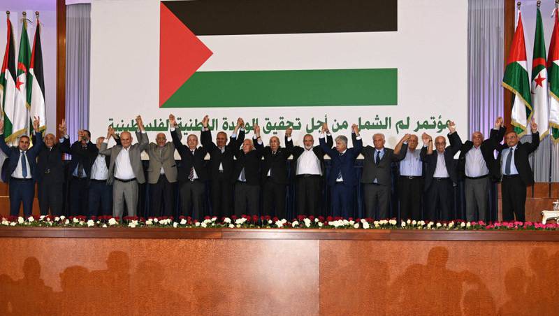 Algerian President Abdelmadjid Tebboune with members of Palestinian factions after signing an inter-Palestinian reconciliation deal in Algiers on Wednesday. AFP