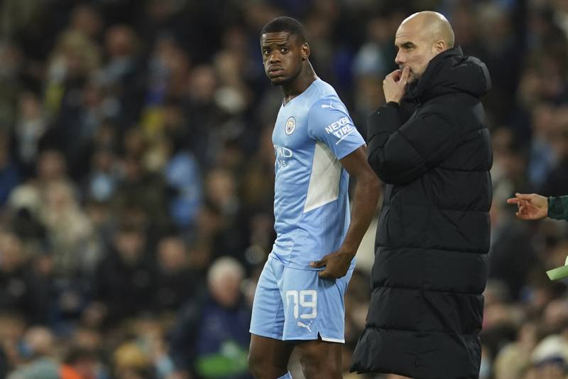 Coach Pep Guardiola stands next to Luke Mbete as he replaces Manchester City's Aymeric Laporte. AP