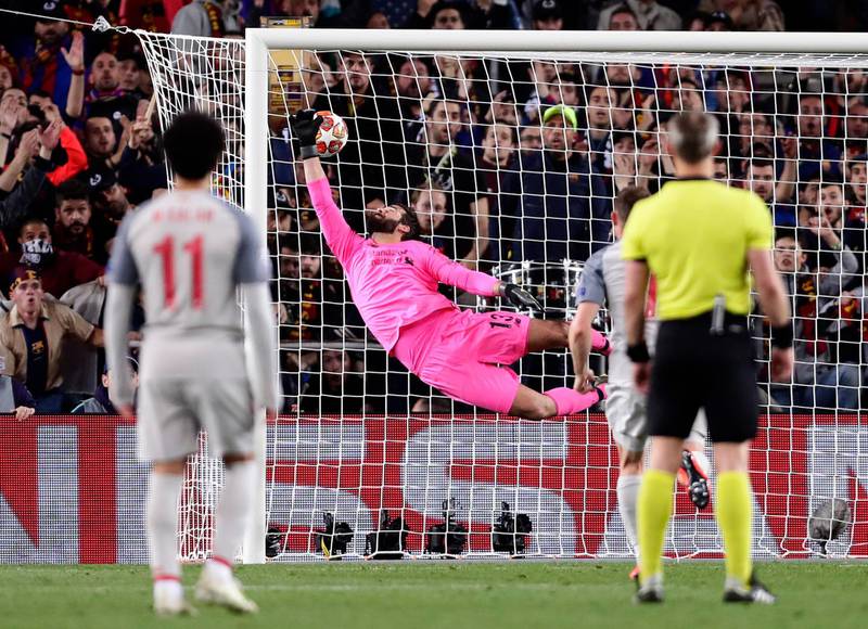 Liverpool goalkeeper Alisson fails to stop Barcelona's Lionel Messi's shot on goal, giving Barcelona a 3-0 lead. Manu Fernandez / AP Photo