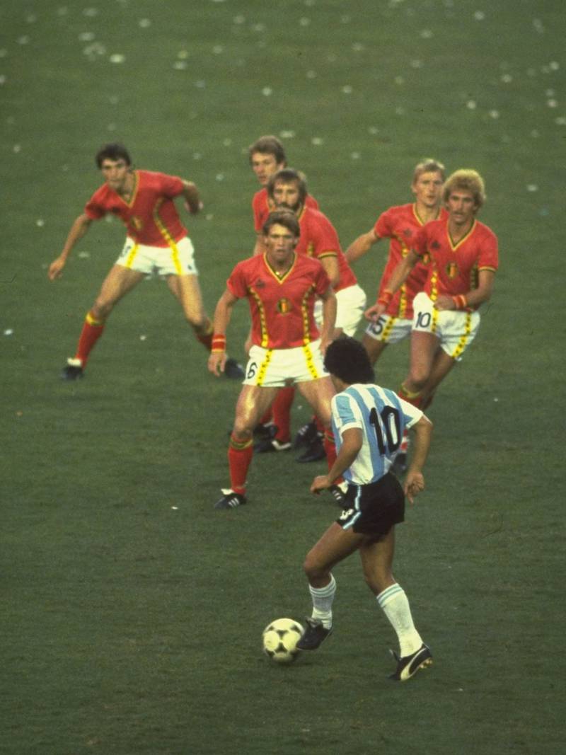 1982 World Cup, Spain. A prowling Diego Maradona of Argentina is confronted by a posse of bewildered Belgium defenders during their match at the World Cup in Spain. Argentina were knocked out of the tournament after losing to Brazil and Italy, the latter beating West Germany in the final to seal the trophy. Getty Images