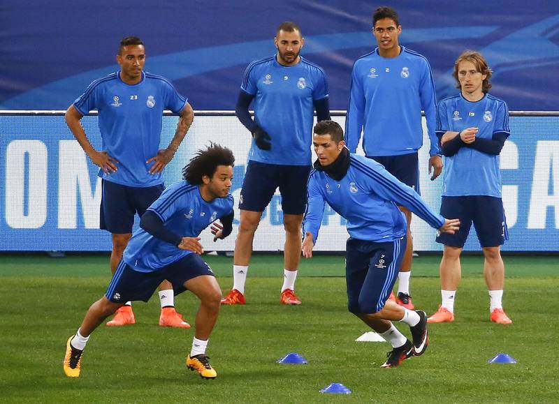 Real Madrid's Cristiano Ronaldo (front right) and Marcelo (front left) warm up during a training session prior to their Champions League match against AS Roma at the Olympic stadium in Rome, Italy February 16, 2016. REUTERS/Tony Gentile