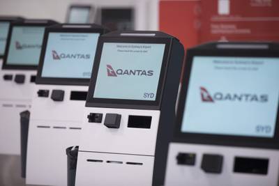 Qantas Airways' self check-in machines at Sydney Airport in Australia. The airline reported bumper profits on August 24. Bloomberg