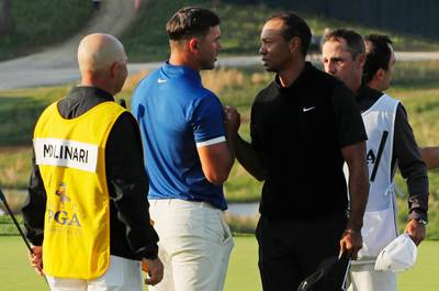 Brooks Koepka and Tiger Woods shake hands after finishing the second round of the PGA Championship golf tournament, Friday, May 17, 2019, at Bethpage Black in Farmingdale, N.Y. (AP Photo/Andres Kudacki)