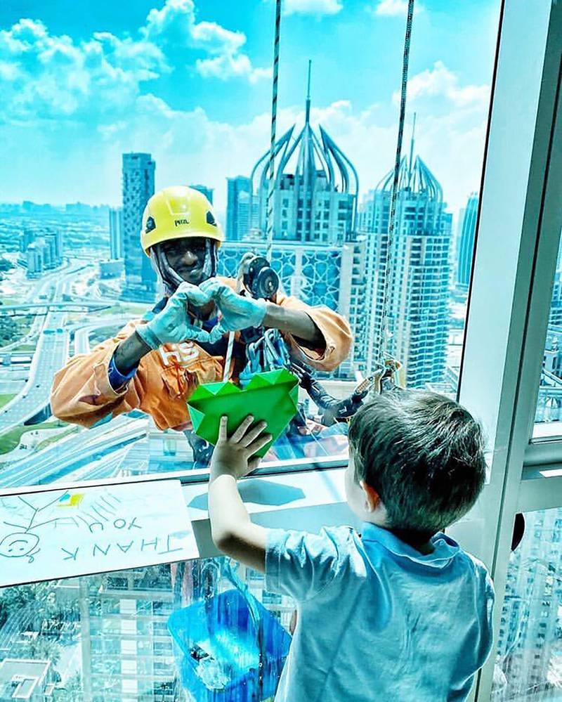 One UAE resident shares a photo of her son connecting with the window cleaner at their home. Instagram / @k.q1603
