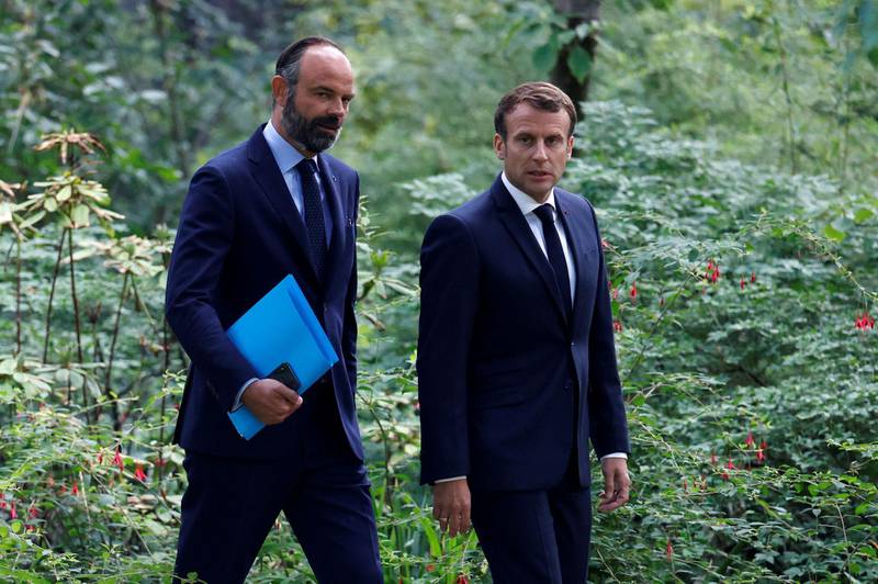 French President Emmanuel Macron (R) and former French Prime Minister Edouard Philippe arrive for a meeting with members of the Citizens' Convention on Climate (CCC) to discuss over environment proposals at the Elysee Palace in Paris, June 29, 2020. AFP