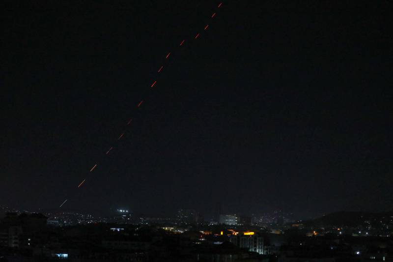 Celebratory gunfire light up part of the night sky after the last US aircraft took off from the airport in Kabul early on August 31, 2021. AFP