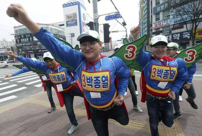 Opposition parliamentary campaigners dressed as Superman perform on a street in Iksan, southwestern South Korea. Yonhap / EPA