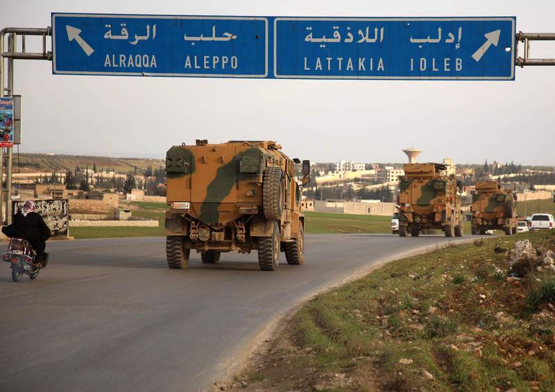Turkish military vehicles drive in a convoy headed for the south of Idlib province as they pass by the town of Atareb in the western countryside of Aleppo.   AFP