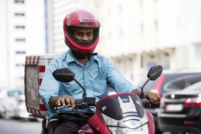 Mohammed Aminuddin, an Indian motorcycle delivery driver for the Hyderabad Star restaurant in the Al Danah area of Abu Dhabi. He and his counterparts navigate difficult and sometimes hostile traffic to keep the capital’s workers fed. Christopher Pike / The National