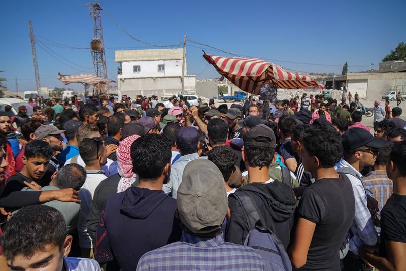 Syrians seeking asylum in Europe via Turkey demonstrate under the name of the Peace Caravan at Bab al-Hawa.