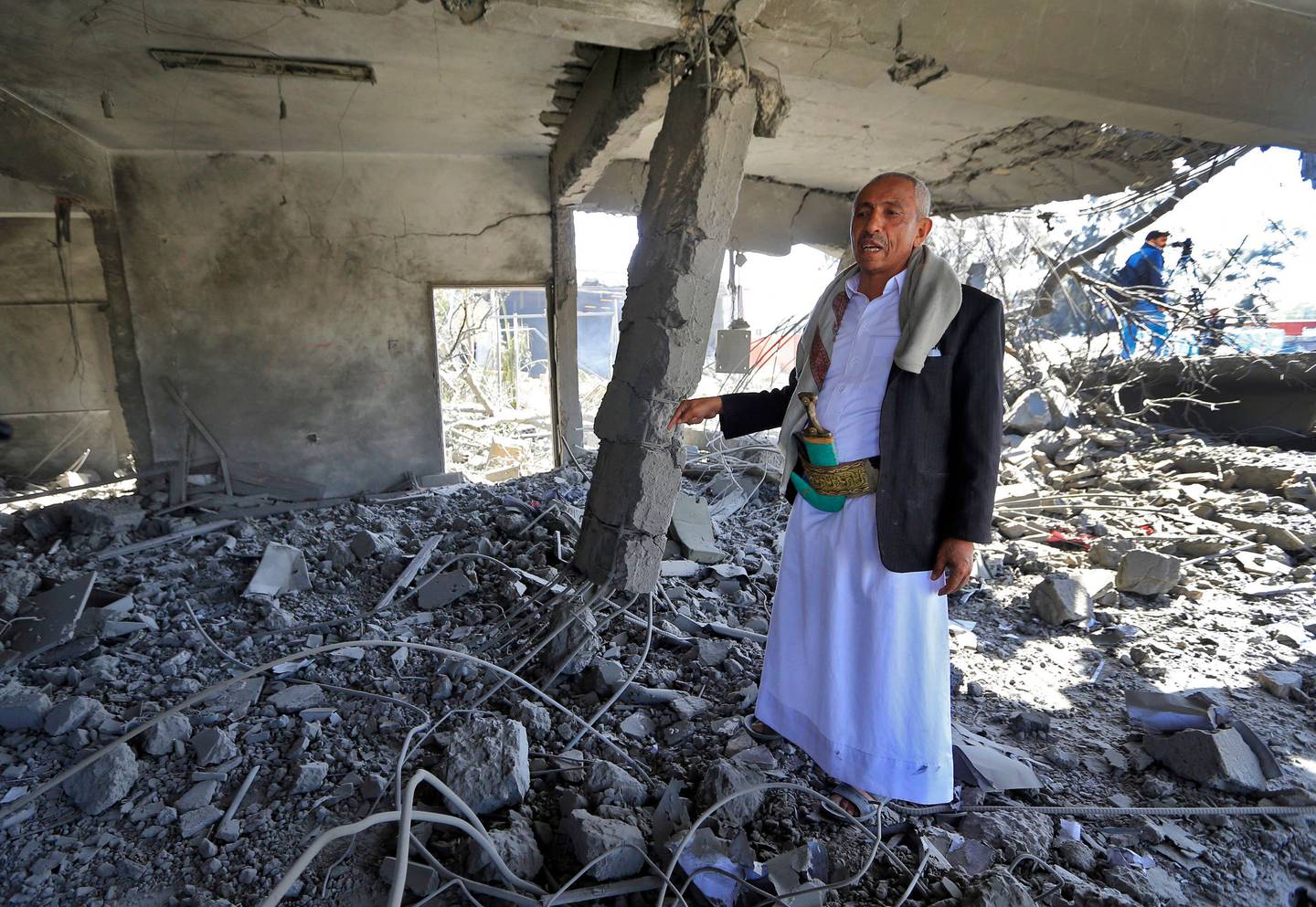 An airport worker in a building destroyed by a reported air strike by the Saudi-led coalition targeting Sanaa airport on December 21, 2021. AFP