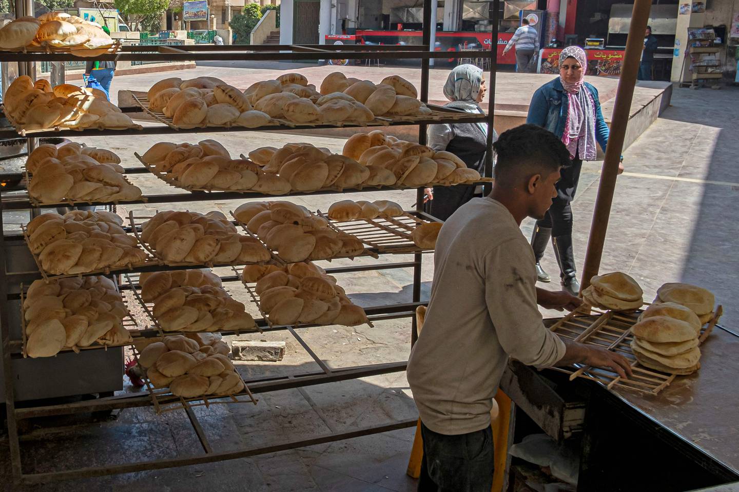 An Egyptian man works at a bakery at a market in Cairo. AFP
