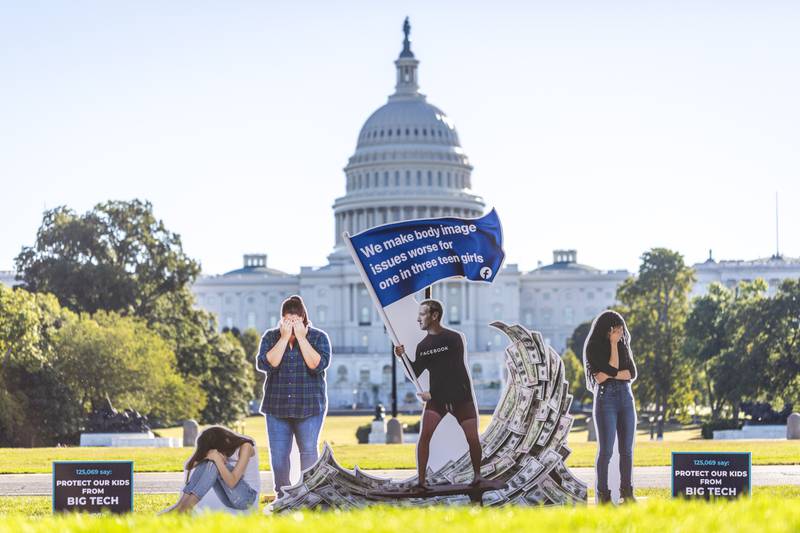 Protest group SumOfUs erected a 2.3-metre tall visual protest outside the US Capitol in Washington depicting Facebook chief executive Mark Zuckerberg surfing on a wave of cash, while young women around him appear to be suffering. AP