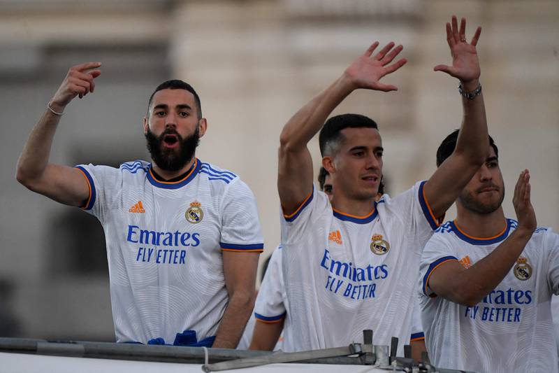 Real Madrid players Karim Benzema and Lucas Vasquez celebrate on the Plaza Cibeles square in Madrid after securing the club's 35th La Liga title. AFP