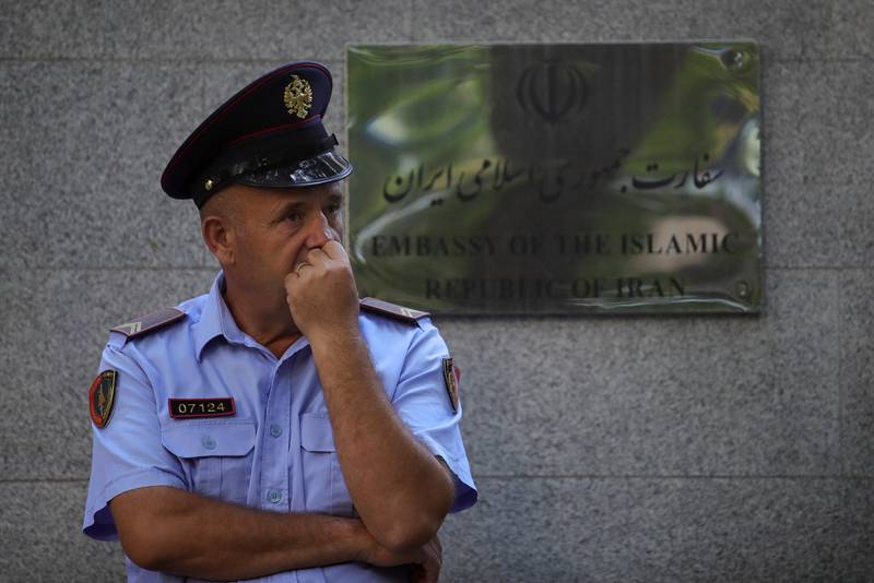 An Albanian police officer stands in front of the Iranian embassy. Reuters