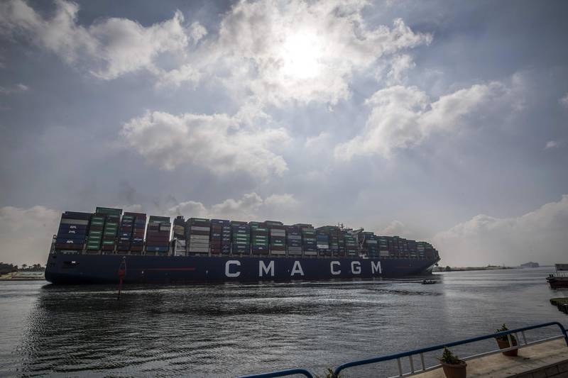 A container ship sails through the new section of the Suez Canal in the Egyptian port city of Ismailia. AFP
