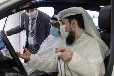 Visitors check out the UAE's first locally produced electric car, Al Damani. The vehicle is manufactured by the M Glory Group.