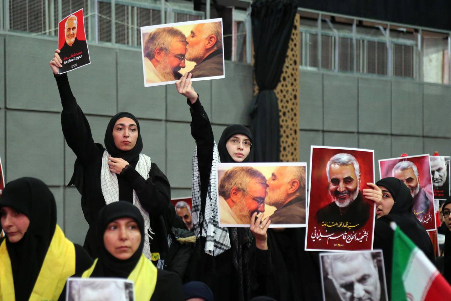 Hezbollah supporters hold pictures of Qassem Soleimani, an Iranian commander, and Hassan Nasrallah, leader of Hezbollah, center, as Nasrallah delivers a televised speech, in Beirut, Lebanon, on Sunday, Jan. 5, 2020. Nasrallah, the leader of Iran’s Lebanese ally, Hezbollah, said the the conflict had entered a “new phase” and the price of Soleimani’s death should be the end of U.S. military presence across the region. Photographer: Hasan Shaaban/Bloomberg