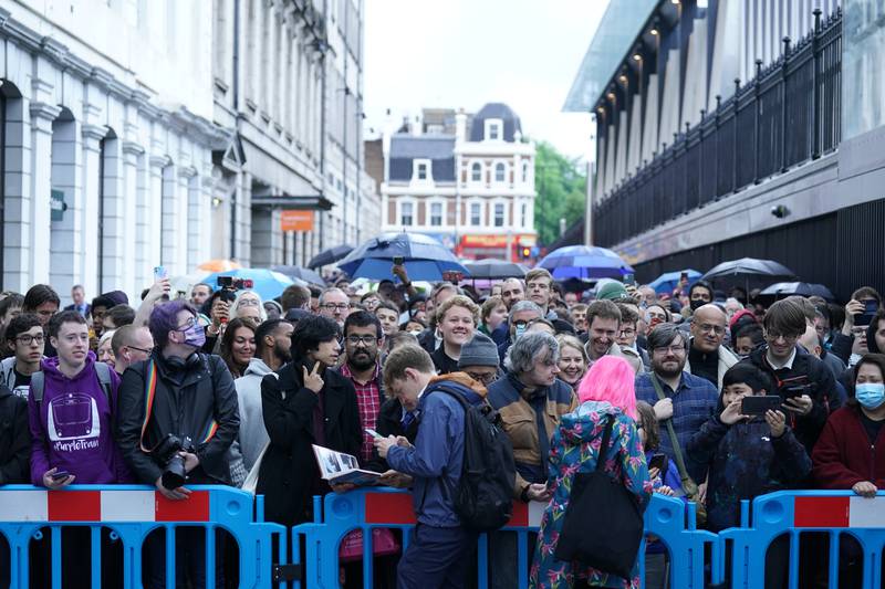 Crowds wait in line to board the first Elizabeth line train to carry passengers at Paddington station. PA