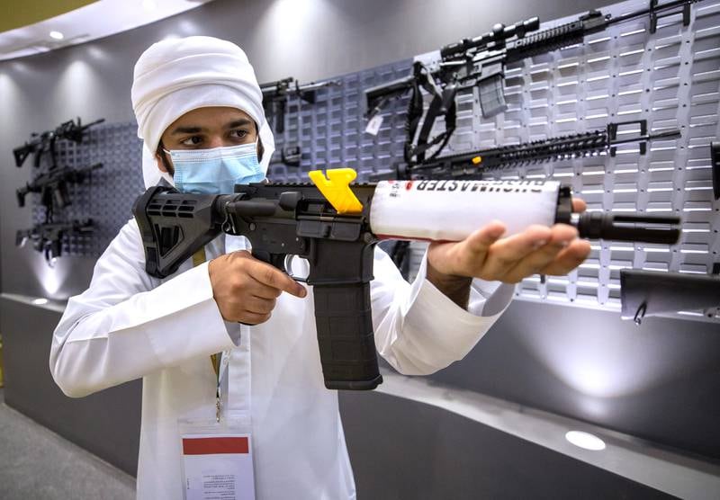A man inspects a weapon at the Bynuna stall at Adihex. Victor Besa / The National