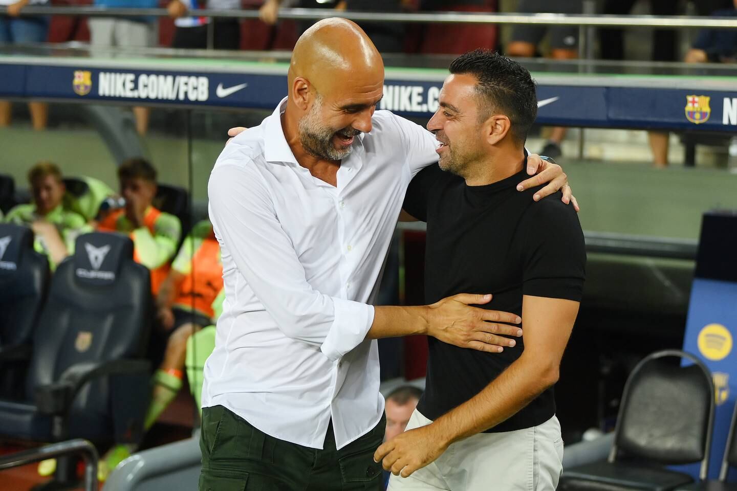 Manchester City manager Pep Guardiola, left, embraces Barcelona counterpart Xavi. Getty Images