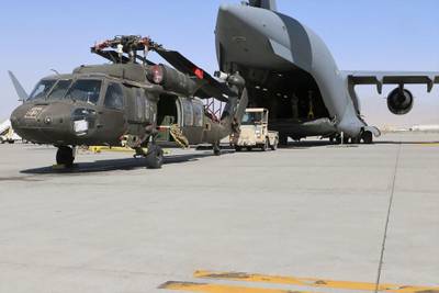 Aerial porters work with maintainers to load a UH-60L Blackhawk helicopter into a C-17 Globemaster III in support of the Resolute Support retrograde mission in Bagram.