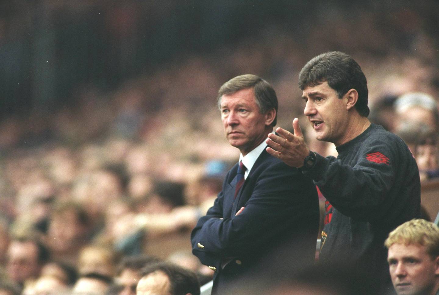14 Oct 1995:  Manchester United Manager Alex Ferguson and Coach Brian Kidd discuss tactics during an FA Carling Premiership match against Manchester City at Old Trafford in Manchester, England. Manchester United won the match 1-0. \ Mandatory Credit: MarkThompson/Allsport