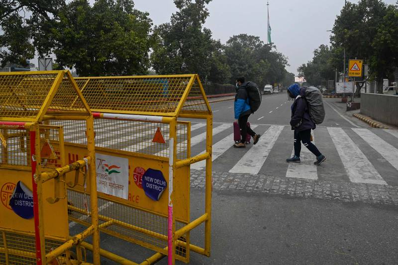 Tourists cross a quiet road in New Delhi.