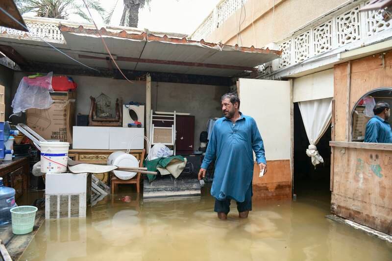 Wali Said, originally from Pakistan, surveys the water damage to his home after flooding in Kalba, Fujairah, UAE. Khushnum Bhandari / The National