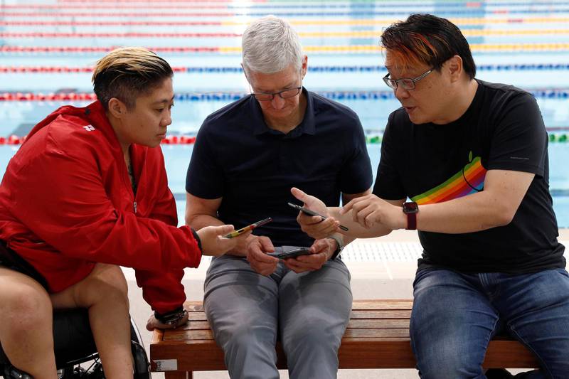Apple's CEO Tim Cook, Singapore Paralympian Theresa Goh and blogger Kin Mun Lee, also known as Mr Brown, share a selfie photo via Airdrop at the OCBC Aquatic Centre, Singapore Sports Hub December 12, 2019. REUTERS/Edgar Su