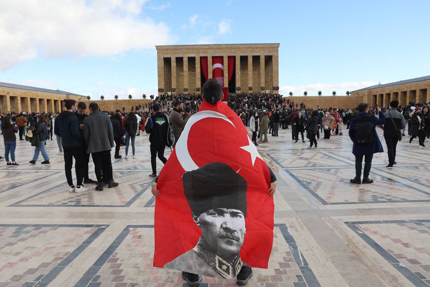 A person with a flag bearing the image of Turkey's founder Mustafa Kemal Ataturk, at the Anitkabir Mausoleum, to mark his 83rd death anniversary, in Ankara on November 10, 2021. AFP