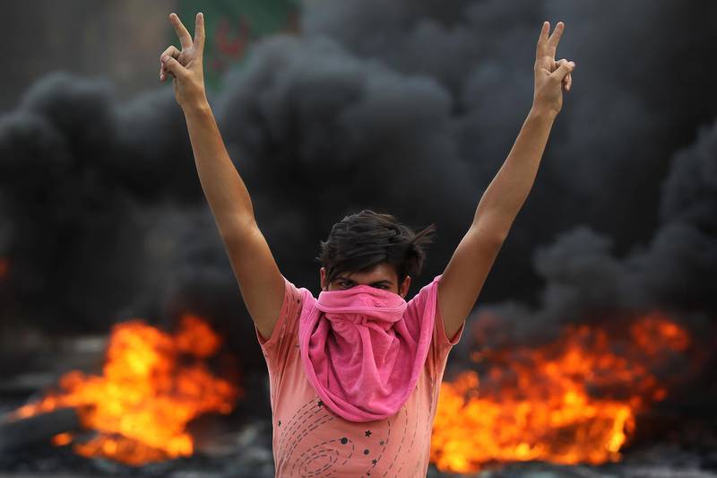 An Iraqi protester flashes the v-sign in the Baladiyat district of the capital Baghdad. AFP