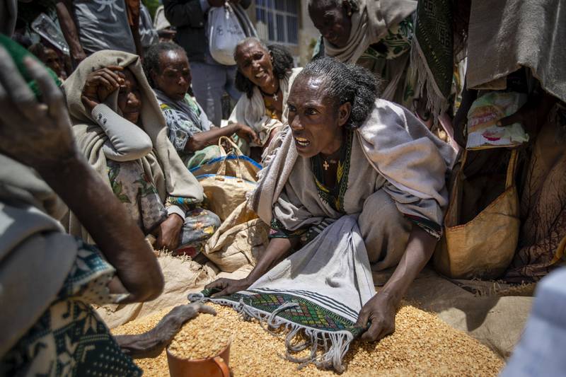 A woman argues over the allocation of yellow split peas in the Tigray region of northern Ethiopia. AP