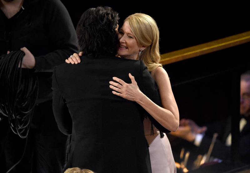 Adam Driver, left, congratulates Laura Dern, winner of the award for best performance by an actress in a supporting role for "Marriage Story" at the Oscars on Sunday. AP