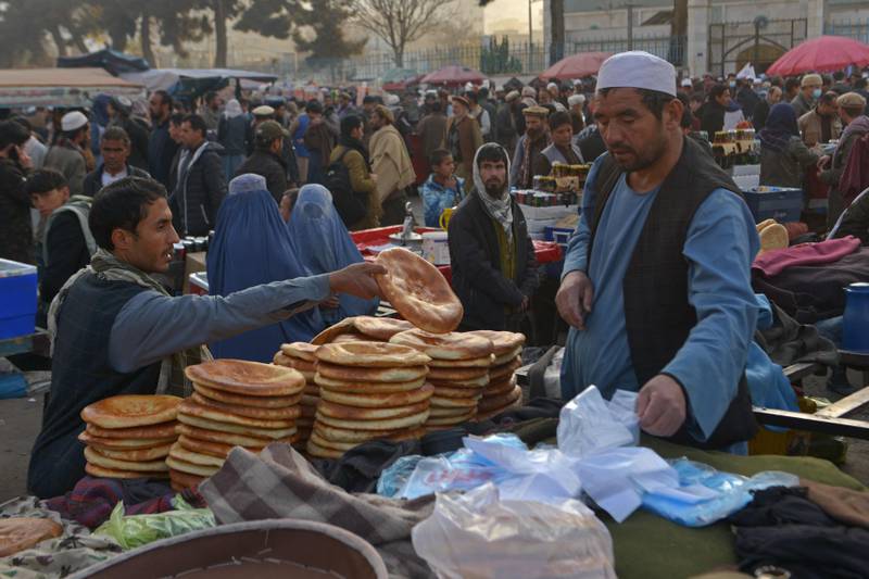 A vendor sells bread at a street market in the Pul-e Khishti area of Kabul. Aid agencies say millions of Afghans are facing severe hunger as winter descends. AFP